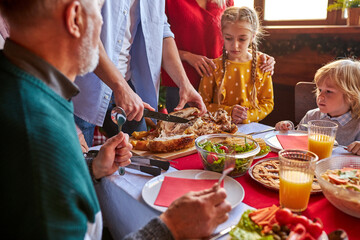 family preparing christmas table together, spend time together at home on the eve of New Year 2021, going to celebrate