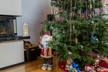 View of room with Christmas decoration and view of cute Santa Claus figure with green Christmas tree.  Beautiful Christmas backgrounds.