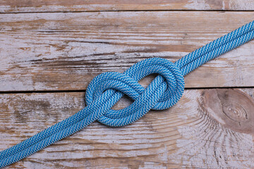 eight knot on a rope on a wooden background