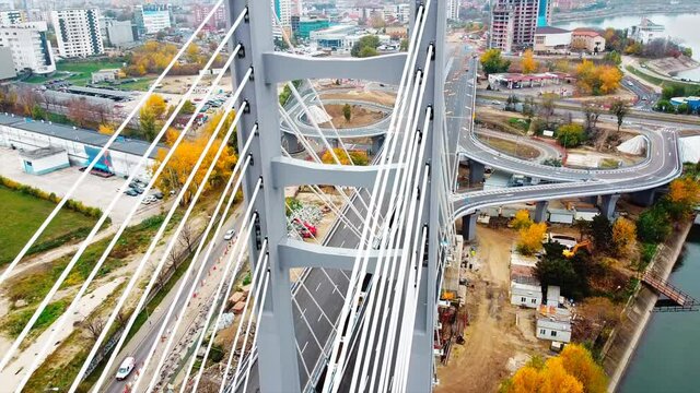 Ciurel passage, bridge over a river with moving cars, construction works near it. View from the drone. Bucharest, Romania