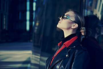 young woman by a skyscraper