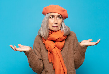 middle age woman looking puzzled, confused and stressed, wondering between different options,...