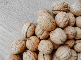 Whole walnuts on a wooden table
