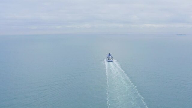 Aerial follow shot of Dover to Calais cross channel ferry in calm sea