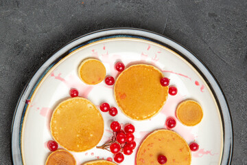 top view yummy little pancakes with red berries on grey desk fruit dessert sweet