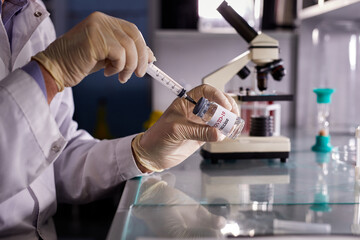 bottle vial vaccine and syringe injection, close-up photo of hands getting liquid