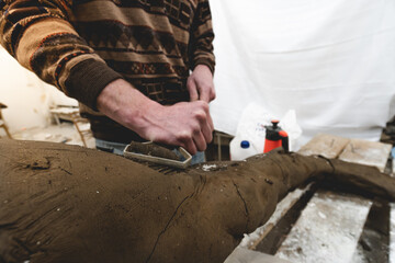 Artist-sculptor working in his workshop, sculpture and art, crafts