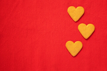 Heart shaped gingerbread cookie on red background