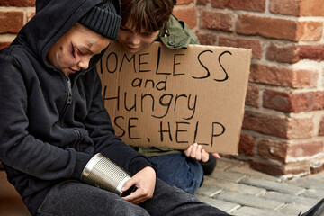 street boys count the money, think whether there is enough for shelter or food, holding cardboard...