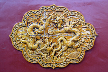 Wutaishan, Shanxi Province in China. Decorative tiles with dragons on a wall at Pusading Monastery (Bodhisattva Summit Monastery). Wutaishan is one of the four sacred mountains in Chinese Buddhism.