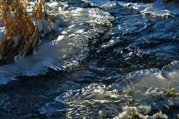 A river flowing between frozen banks