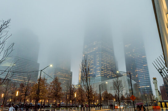Low Angle View of Lower Manhattan Skyscrapers on a Foggy Night in New York City, USA