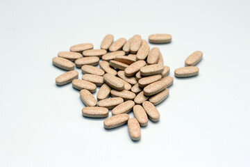 Handful of vitamin pills on white background