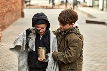 abandoned caucasian kids cry in city streets, ask for money and help, poor and dirty without home