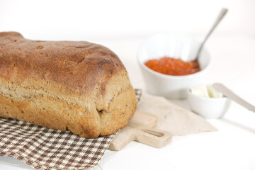 Slices of bread with red caviar on plate on white background. Top view. Copy space.
