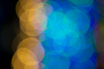 Multi-colored large bokeh spots in blue and yellow. Bokeh from a Christmas garland.