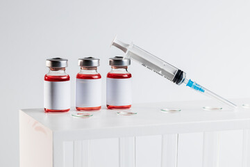 medical vaccine vial with blank label over laboratory equipment. studio shot. copy space. vaccine and vaccination concept