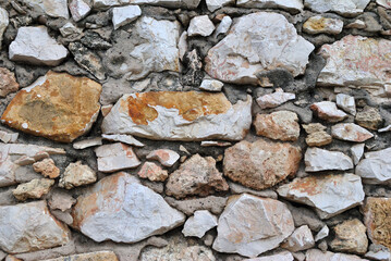 Close Up of Rugged Textured Rocks in Old Stone Wall