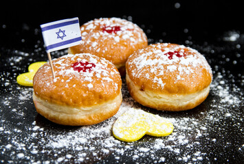 Hanukkah donuts with powdered sugar and the Israeli flag