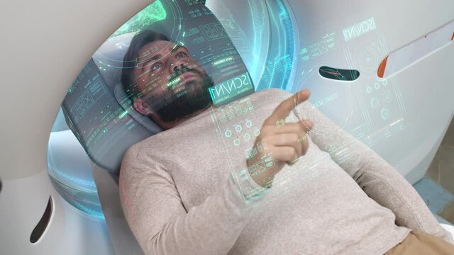 Medium close-up of caucasian man doing innovational computer tomography lying in futuristic white capsule with sensory holoographic screen scanning his lungs