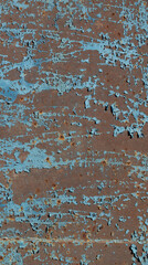 Fototapeta na wymiar Texture of a rusty metal surface covered with blue peeling paint.