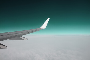 The wing of an airplane in a pure day sky. Between heaven and earth.