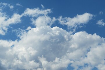 Big fluffy clouds in blue sky, natural background