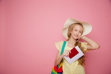 Cute girl on a pink background going on vacation