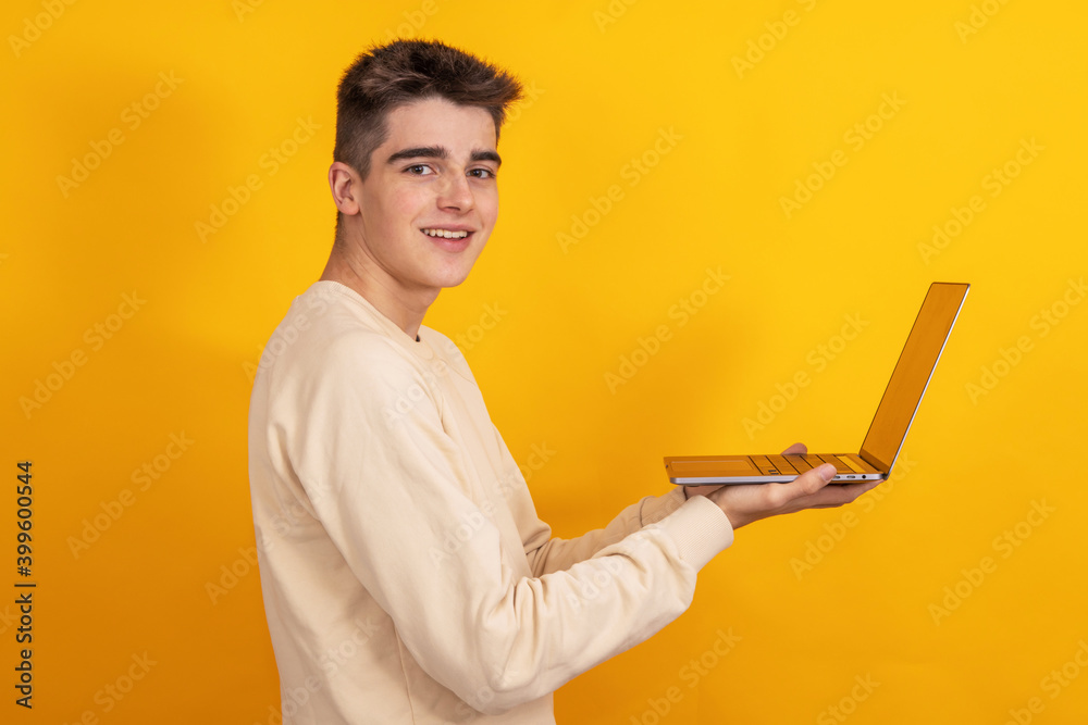 Wall mural young student or teenager with laptop isolated on background