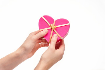 Hands handing over a heart shaped gift on white background, copy space