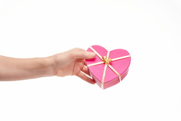 Hand handing a heart shaped gift on white background, copy space