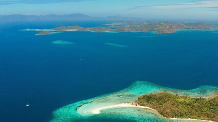 aerial seascape tropical island with sand bar, turquoise water and coral reef. Ditaytayan, Palawan, Philippines. tourist boats on tropical beach. Travel tropical concept. Palawan, Philippines