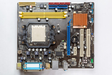 Old computer motherboard on white isolated background.
