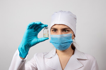 A doctor or lab technician holds a vial with a vaccine. Vaccination against tuberculosis, rabies,...