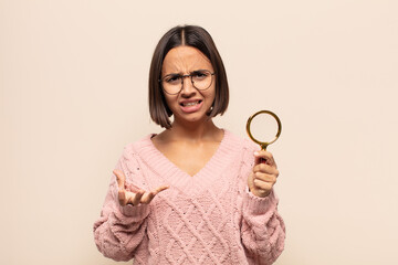 young hispanic woman looking angry, annoyed and frustrated screaming wtf or what’s wrong with you