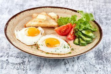 Fototapeta na wymiar fried eggs with vegetables and toast