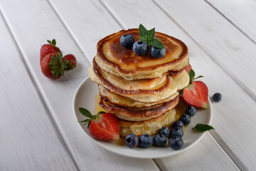 pancakes with fresh blueberry and honey on wooden rustic table