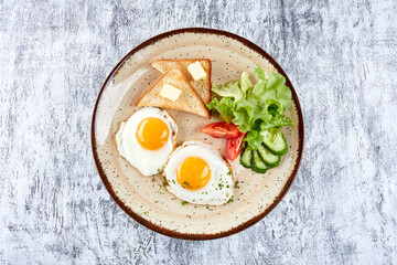 fried eggs with vegetables and toast
