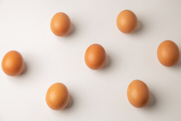brown chicken eggs on color background