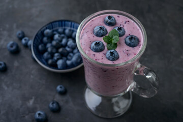 blueberry smoothie with  fresh berries on table