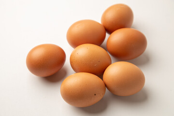 brown chicken eggs on color background