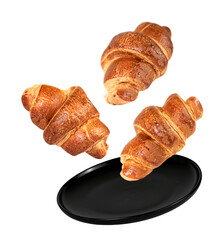 Black plate and three croissants isolated on white background.