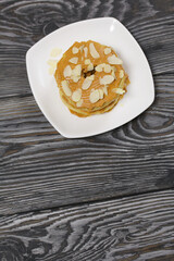 Eclairs cake smeared with cinnamon cream. On black pine boards.