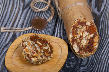 An energy bar made of dried fruits, nuts and seeds. Wrapped in edible paper. The wax seal is...