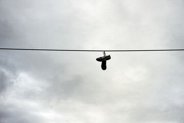 Shoes hanging on a wire outside