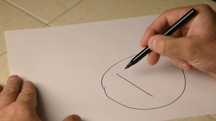 A man draws bitcoin on paper with a black felt-tip pen, a graph of the decline in the growth of virtual money. - Powered by Adobe