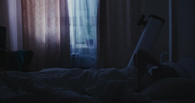 A woman lies at night on a bed in a room with moonlight and cannot sleep due to insomnia
