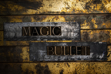 Magic Bullet text on vintage textured silver grunge copper and gold background