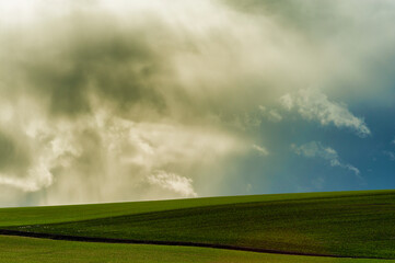 Obraz na płótnie Canvas Minimalist of stormy skies over agricultural field