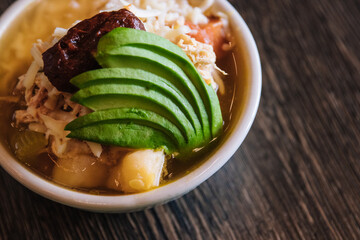 Mexican soup topped with avocados